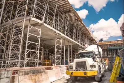 An illustrative image showcasing prefabricated building components being manufactured in a factory-controlled environment, highlighting the efficiency and precision of off-site construction methods.